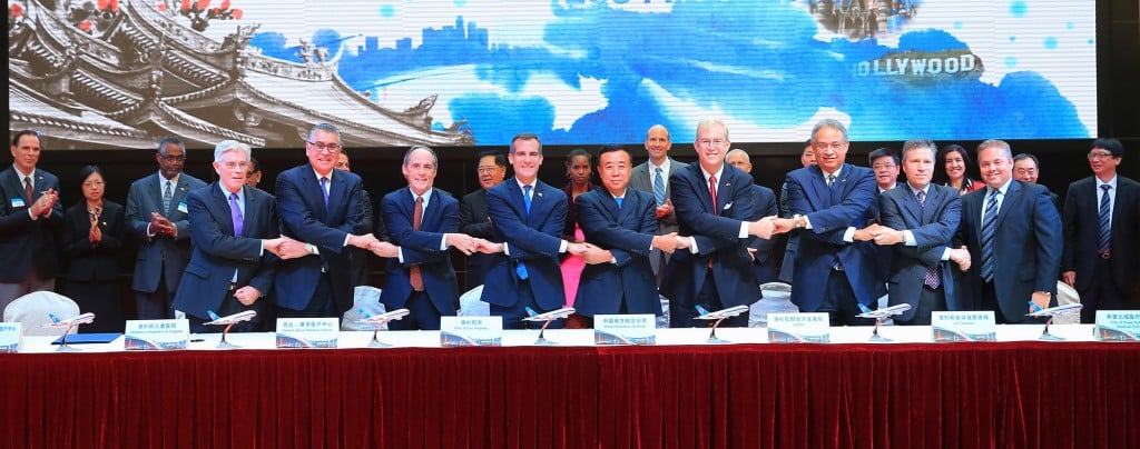 Delegates join hands to celebrate signing historic MOU for medical travel from China to LA area medical centers. (L to R) Thomas Coates (UCLA Health), Rich Cordova (Children's Hospital), Tom Priselac (Cedars-Sinai), Mayor Eric Garcetti, Chairman Si (China Southern), Bill Allen (LAEDC) Ernest Wooden (LA Tourism), Harlan Levine (City of Hope) and Scott Evans (Keck Medicine at USC) -Nov 17, 2014